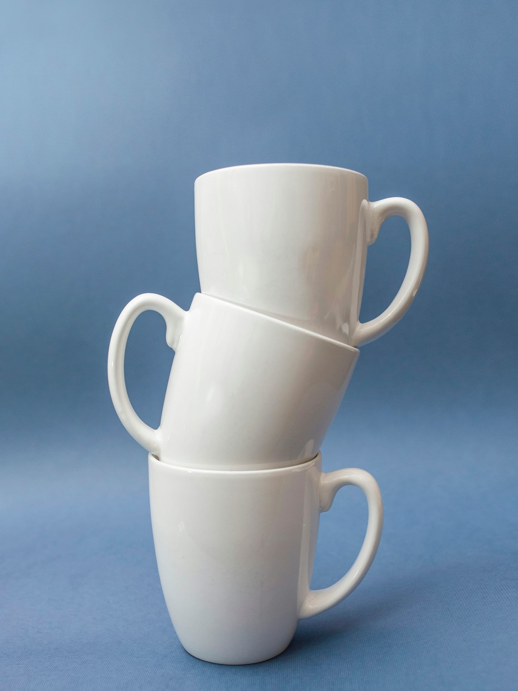 Three plain ceramic cups stacked together