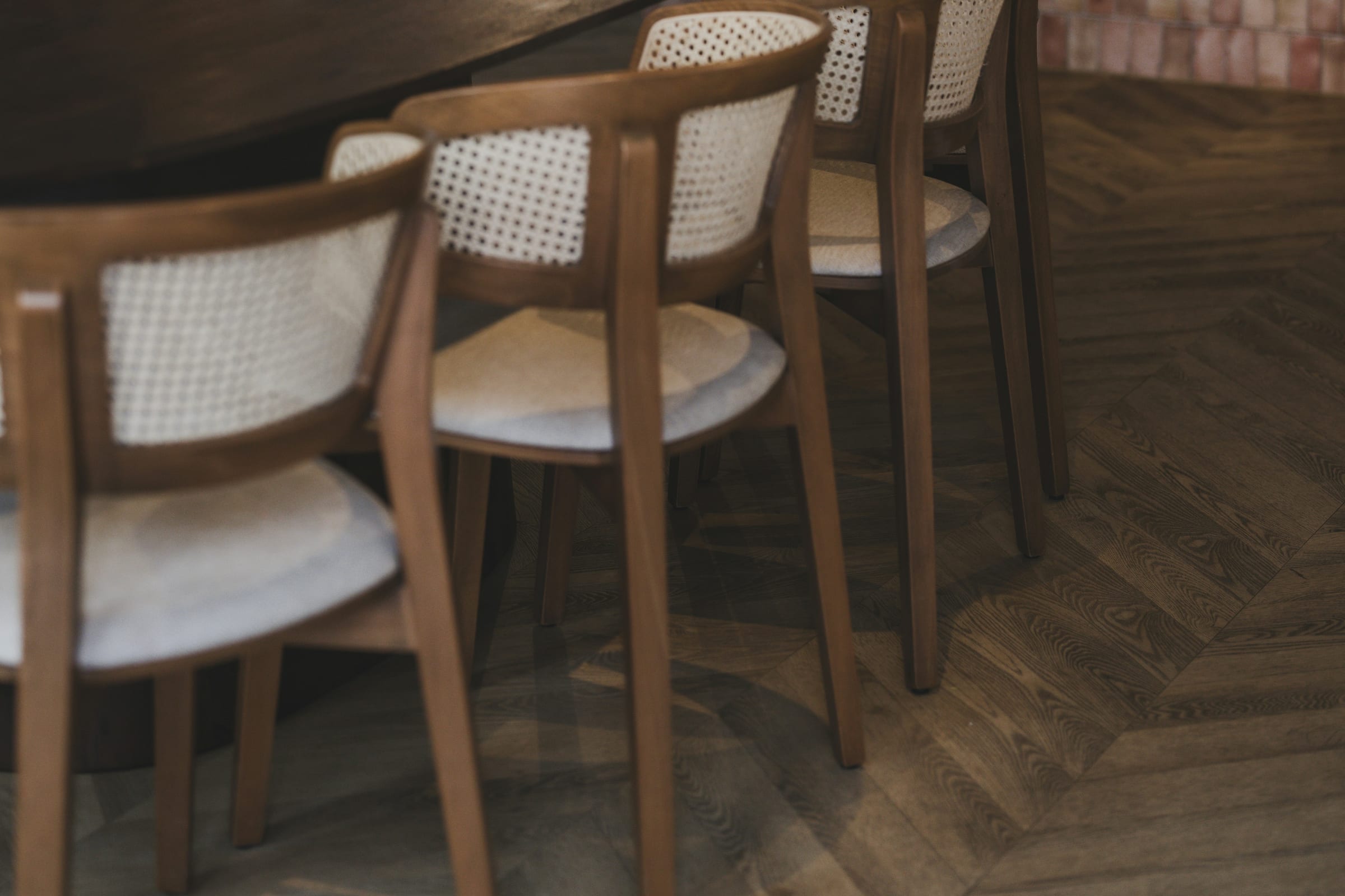 Unoccupied wooden chairs and tables in a café